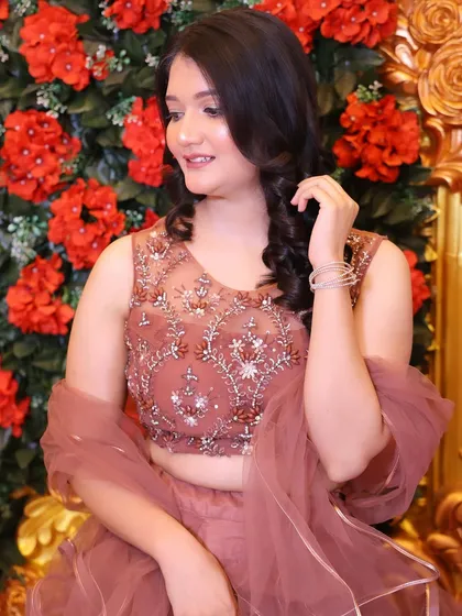 A close-up of the shimmery blouse and soft makeup. This look is all about subtle glamour.
