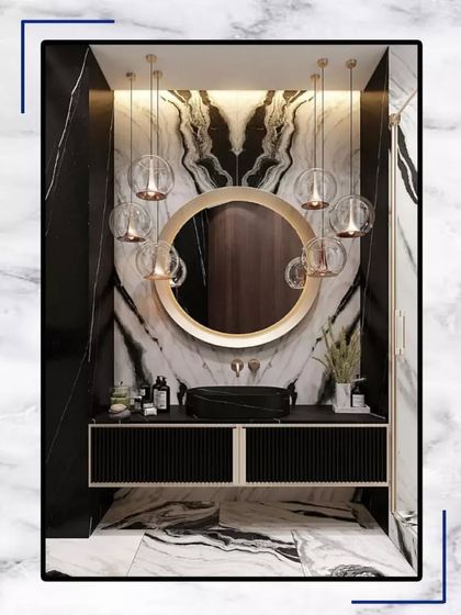 Relax, refresh, revive. This bathroom uses black and white marble to create a dramatic and modern look, complete with a round mirror and globe pendant lights.