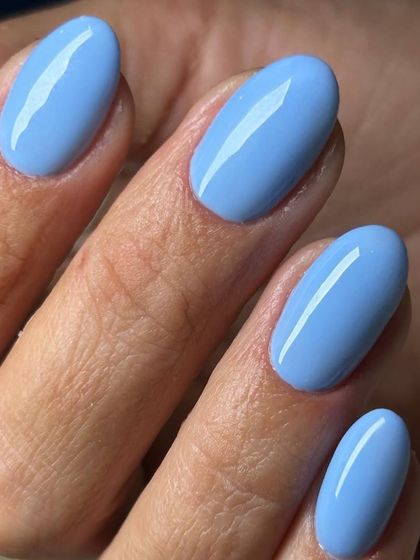 A beautiful sky blue polish on oval-shaped nails. This bright and cheerful color is perfect for adding a playful touch to your look.