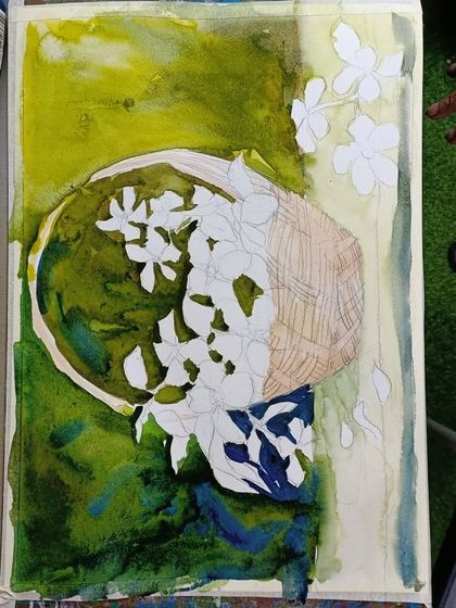Another angle of the floral still life, showing the process of masking and layering watercolors to build up the composition.
