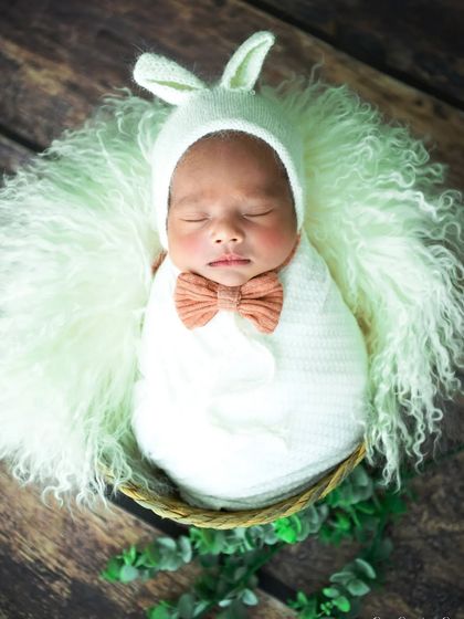 A slightly different angle of the bunny-themed shoot, showing the baby with a cute bow tie.