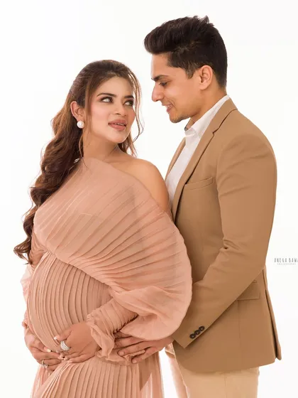 A sophisticated couple's portrait with a focus on their loving gaze. The coordinated outfits and soft lighting create an elegant and timeless look.