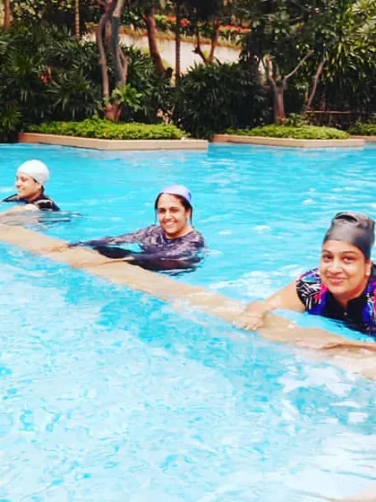 Members take a moment during a session. Regular participation in aqua aerobics helps improve joint health, increase muscle strength, and aid in weight loss.
