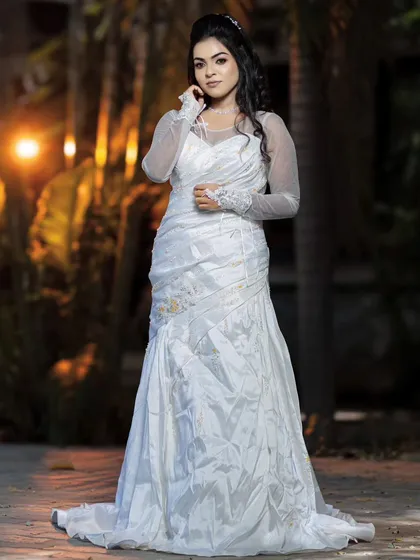 A full-length shot of a model in a white gown, perfect for a Christian wedding. The makeup is glamorous and complements the elegant dress.