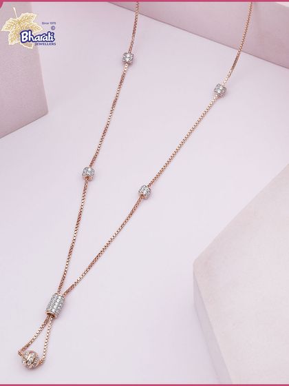 A delicate rose gold necklace designed for quiet luxury. This piece features an adjustable lariat design with Swarovski diamond-studded beads that add a subtle sparkle to your everyday style.