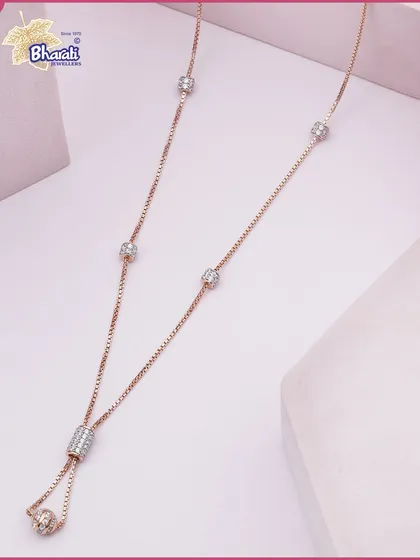 A delicate rose gold necklace designed for quiet luxury. This piece features an adjustable lariat design with Swarovski diamond-studded beads that add a subtle sparkle to your everyday style.