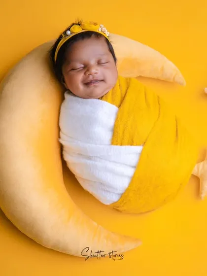 A happy, sleepy smile from our little star on the moon, a perfect shot to end this sweet series.