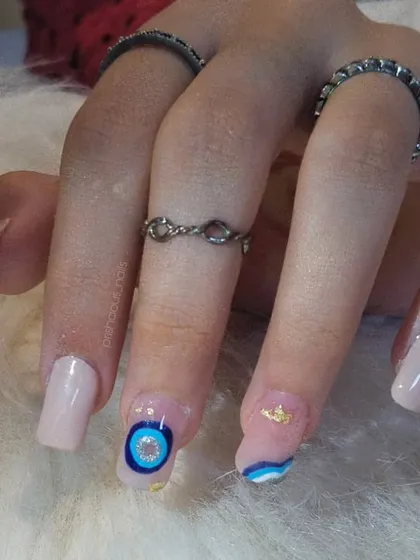The full evil eye set on square-shaped extensions. The nude base makes the blue and gold details really pop.