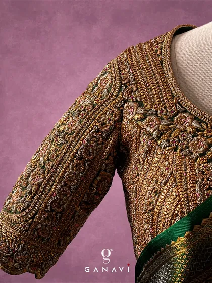 This is where fabric becomes architecture. A close-up of a signature blouse sleeve, showcasing the dense, three-dimensional embroidery that is a hallmark of my work. Every thread is meticulously placed to create a pattern rich in texture and heritage.