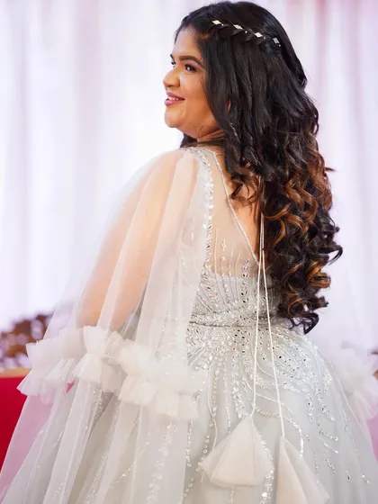 This client was getting ready to celebrate her anniversary in style. Her ethereal silver gown was paired with soft makeup and voluminous curls for a look that was pure elegance.