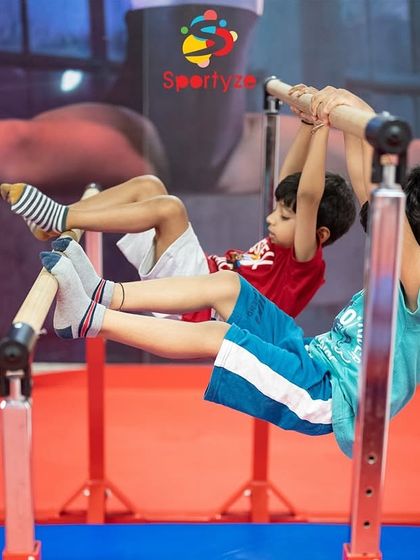 Working together on the parallel bars. This exercise is excellent for building the core and upper body strength that is essential for all areas of gymnastics.