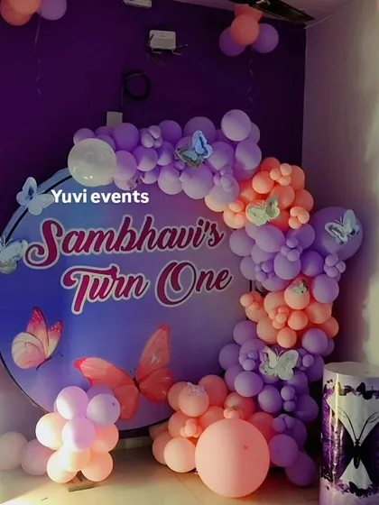 A closer look at the custom circular backdrop and balloon garland for the butterfly-themed first birthday.