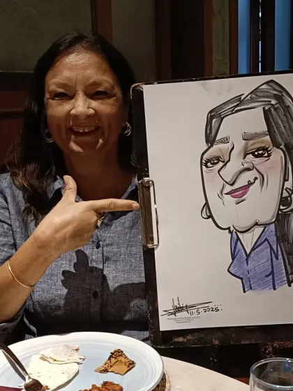 She's pointing to her caricature with a big smile. I love it when my clients are this happy with their portraits.