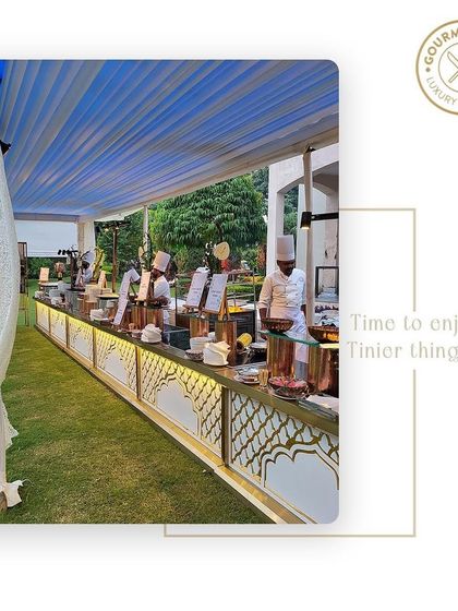 A long buffet station at an outdoor daytime event, staffed by our professional chefs.
