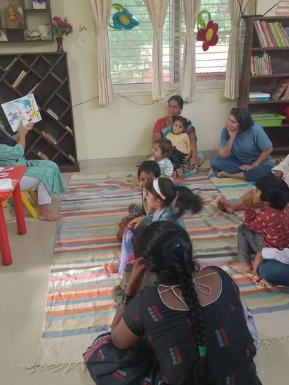 A wider shot of the chameleon story session, showing how even the parents are drawn into the narrative.