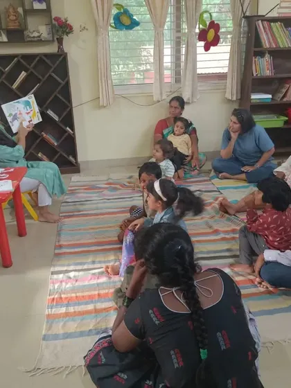 The full group is visible here, including parents, all engaged in the story about self acceptance.