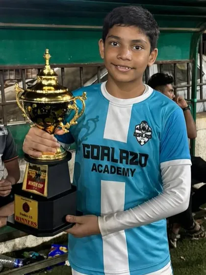 Another one of our champions from the Under-15 team, celebrating with the Winter Cup winner's trophy.