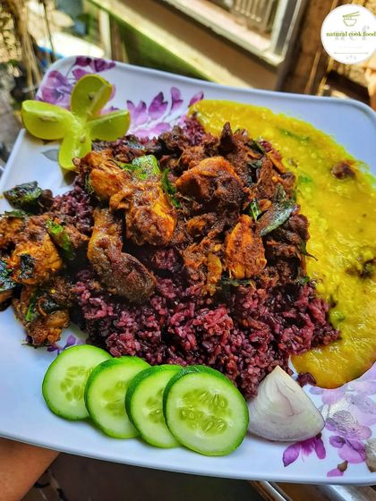 A healthy and delicious meal of Manipuri black rice served with a spicy chicken and curry leaf stir fry and a side of dal.