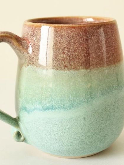 My Pist-a-chio mug features a beautiful, flowing blend of blushing rouge and soft green glazes. The colors melt into each other, creating a dreamy, watercolor-like effect.