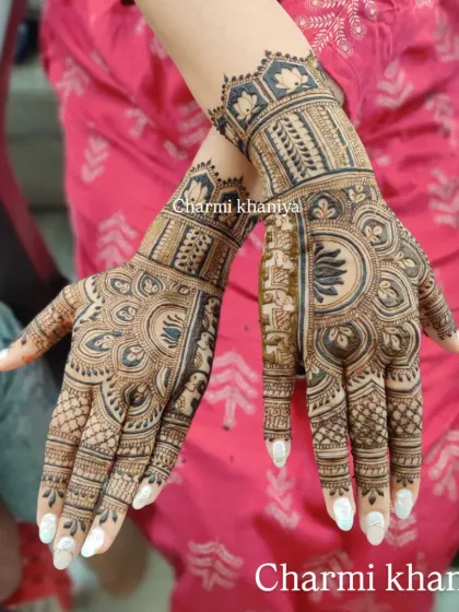 A stunning full-hand mehendi with a bold lotus as the centerpiece. The surrounding patterns are a mix of traditional Indian henna styles, creating a rich and complete look.