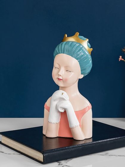 This charming showpiece of a girl in a crown adds a touch of sweet royalty to your decor. The soft pastel colors and gentle expression make it a lovely accent for a bedroom or vanity.