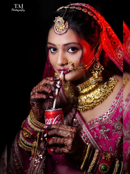 A fun and quirky bridal portrait. The bride sipping a Coke adds a touch of modern personality and humor to the traditional bridal look.