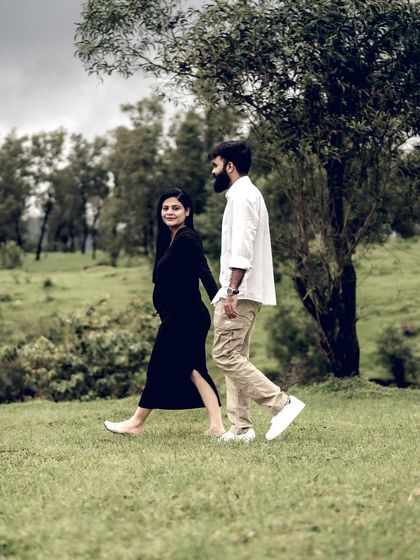 A beautiful shot of the couple taking a stroll through a park. The natural setting and their easy connection make for a lovely, candid portrait.