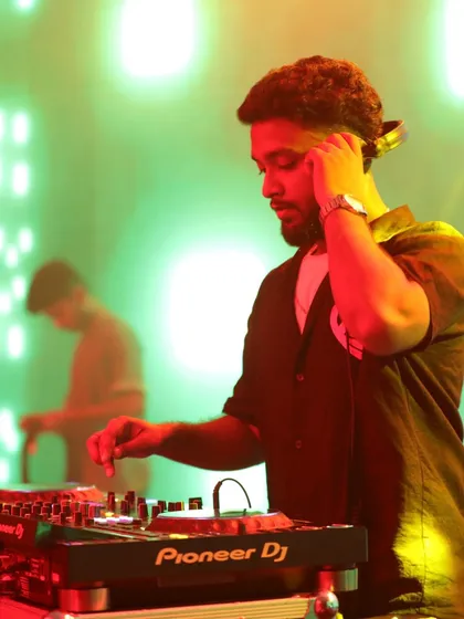 Adjusting my headphones to cue up the next track. This is a classic DJ pose, representing the constant work of listening and preparing.