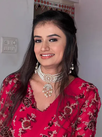 A smiling portrait of this client, her makeup looking flawless.