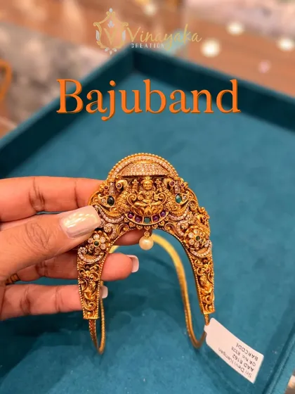 A close-up of a traditional bajuband with multi-color stones and a pearl drop. These armlets are an essential part of a South Indian bride's attire, and I offer many designs for rent.
