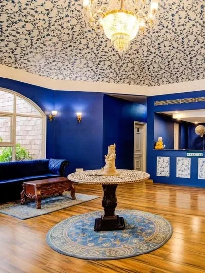 Another view of the Hotel Tivoli reception, where the deep blue walls contrast beautifully with the intricate, Mughal-inspired wallpaper on the domed ceiling.