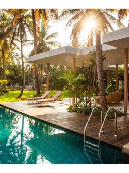 For this private residence, the goal was to create a tranquil oasis. The design seamlessly integrates the swimming pool and deck with the surrounding palm grove, using clean lines and natural materials to craft a space for quiet relaxation.
