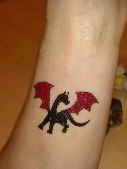 A fierce little dragon in black and red glitter. This is a fantastic choice for fantasy, castle, or mythical creature-themed events.
