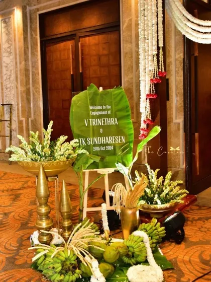 The first impression sets the tone for the entire celebration. We designed this elegant entrance for an engagement, using a custom banana leaf sign, brass elements, and fresh tuberoses to welcome guests with classic charm.