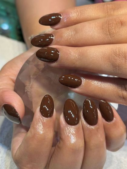 Another angle of the rich, fall-inspired brown refill nails, showing their glossy finish.