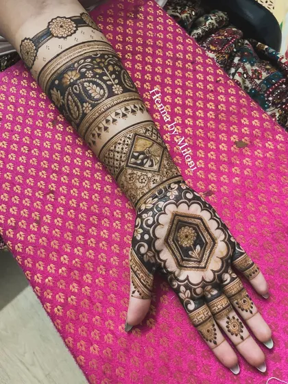 A unique bridal design with a focus on geometric and paisley patterns. The central hexagonal motif creates a modern feel within a traditional framework.