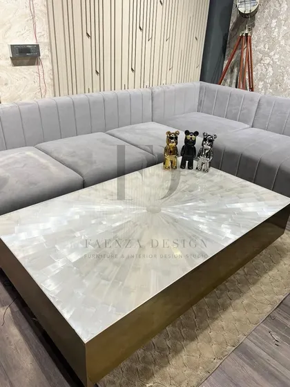 An ultra-luxury center table crafted from selenite stone with a brushed brass base. The natural, crystalline texture of the selenite top makes this a unique and captivating centerpiece.