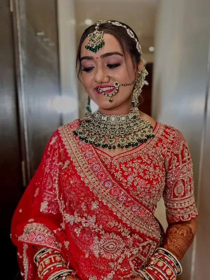 A shy smile from the beautiful bride. Her soft smokey eyes and traditional jewelry create a look of timeless elegance.