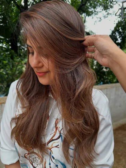 Getting ready for 'Ghar ki shaadi' (a home wedding). This client wanted a glamorous but natural look, so I gave her a rich color melt with soft waves, perfect for the occasion.