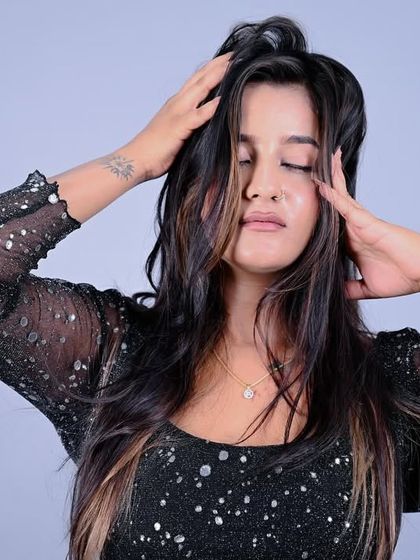 An emotive pose with eyes closed, conveying a sense of calm and introspection.