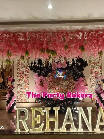 A wide view of the Minnie Mouse stage, showing the impressive scale with the floral ceiling decoration and large marquee letters.