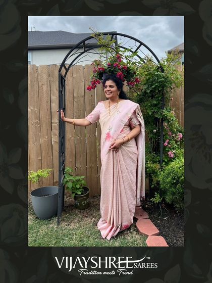 A full-length view of Sapna's elegant floral brocade saree, perfect for a garden party or daytime event.