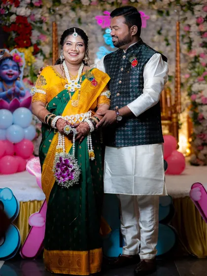 A full-length shot of the couple, showing how the complete floral jewellery set enhances the traditional attire for a baby shower.