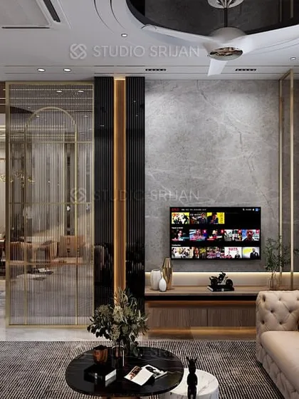 The TV unit is set against a grey marble wall, with the screen flanked by vertical black panels, creating a sleek and modern entertainment hub.