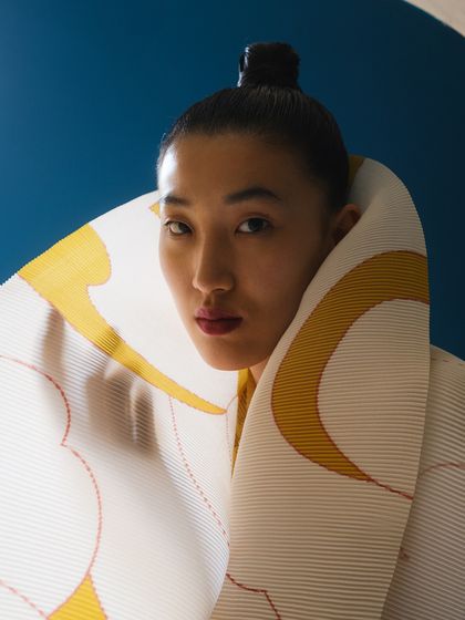 A close-up focusing on the unique collar of this pleated piece by Payal Khandwala. The styling is minimal to let the garment's innovative design speak for itself.