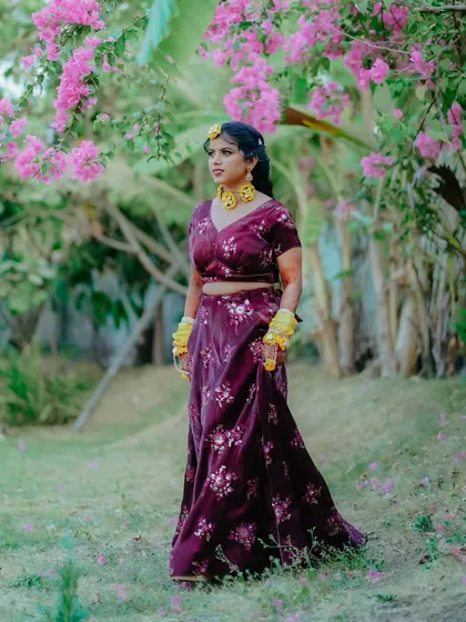 A thoughtful portrait of the bride amidst blooming pink flowers, creating a beautiful and serene image.