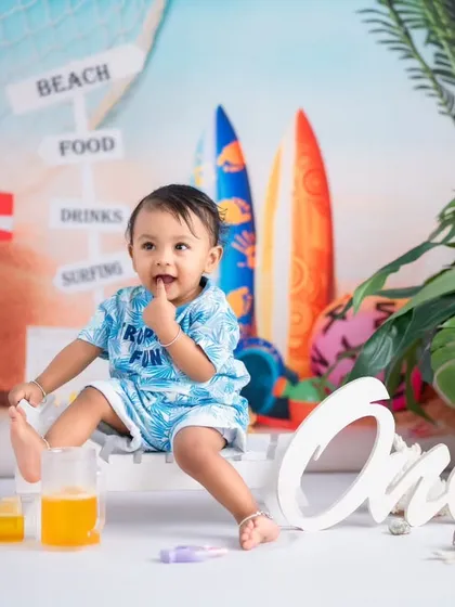 A candid shot of a toddler tasting his fingers during his beach-themed photoshoot. We capture all the cute, unscripted moments that happen during our sessions.