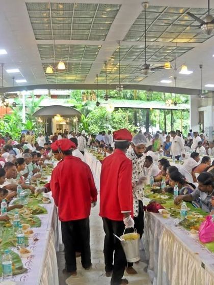 My staff, in red uniforms, serving guests during a marriage ceremony. The different uniforms often denote different service roles, ensuring a well-organized event.