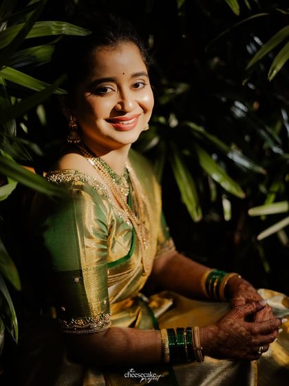 A lovely portrait of the bride nestled amongst green leaves, the play of light and shadow is beautiful.