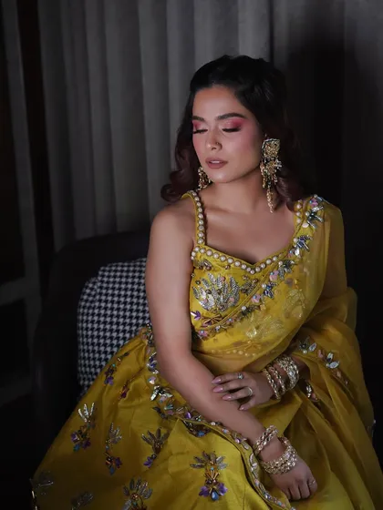 Another shot of this vibrant haldi makeup. The pink eyeshadow really makes her eyes pop and complements the yellow outfit beautifully.